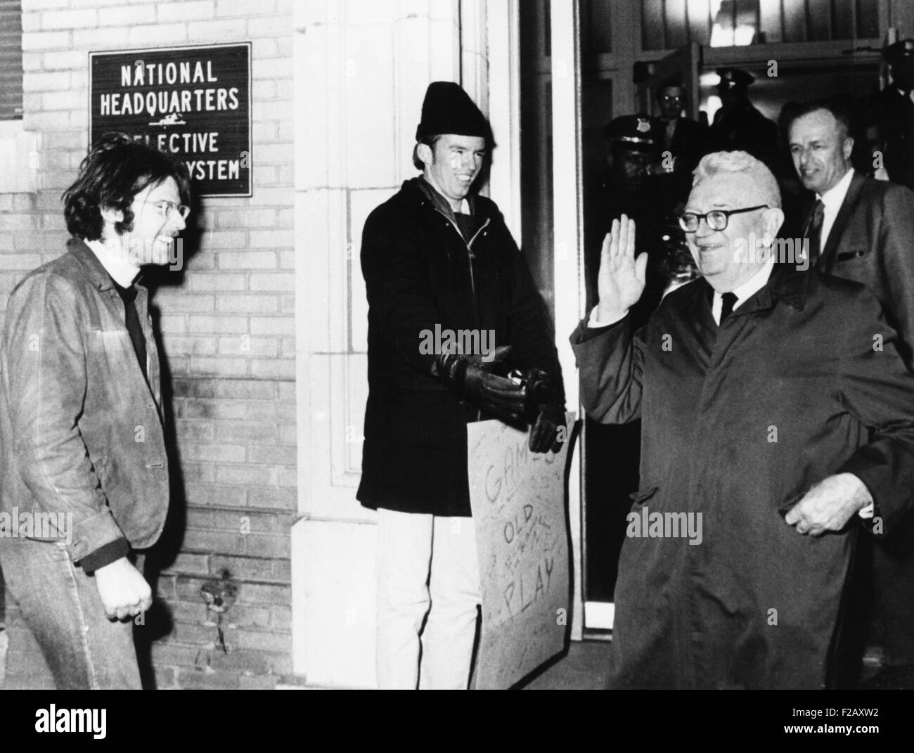 Gen. Lewis Hershey waves to protesters outside the Selective Service HQ after draft lottery. Dec. 1, 1969. (CSU 2015 9 956) Stock Photo