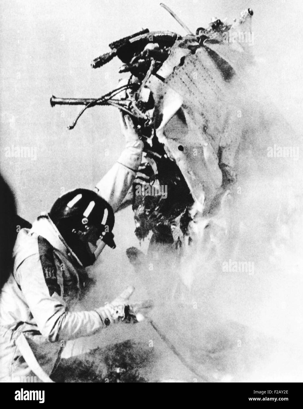 Graham Hill, lifts part of the burning wreckage to clear unconscious Peter Revson. March 22, 1974. Revson, 35, was killed driving his Ford-Shadow One, when its steering system failed during practice for the South African Grand Prix. (CSU 2015 9 913) Stock Photo