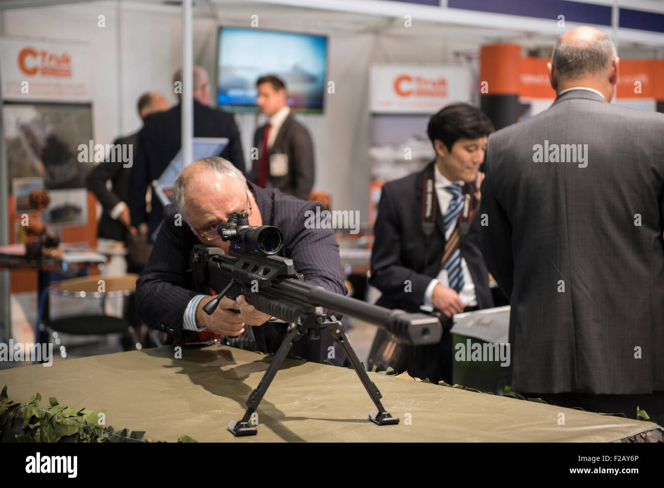 London, UK. 15th September, 2015. A man looks through the sight of a large gun that’s on display at DSEI, the world’s largest international defence & security exhibition held at London’s ExCel centre. Credit:  Peter Manning/Alamy Live News Stock Photo