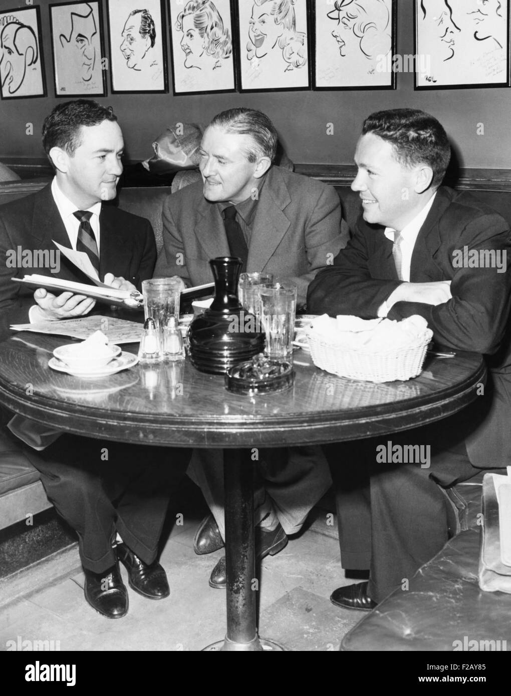 Radio script writers, Jerry Lawrence (left), and Bob Lee (right), with James Hilton (center). May 27, 1952. They were collaborating on a script based on the 19th c. novel LORNA DOONE for THE HALLMARK PLAYHOUSE, a CBS Radio series hosted by James Hilton. Lawrence and Lee wrote the 1955 play INHERIT THE WIND and AUNTIE MAME. They wrote in partnership until the 1980s. English novelist James Hilton's best know works are 'Lost Horizon' and 'Goodbye, Mr. Chips.' (CSU 2015 9 861) Stock Photo