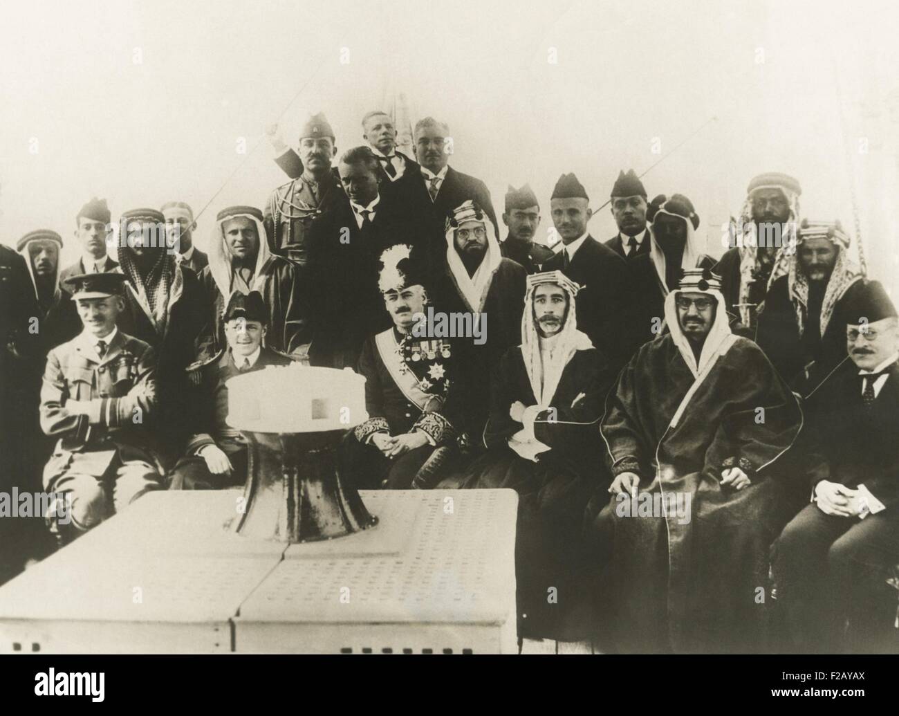 King Faisal of Iraq and King Ibn Saud of Najd signed a peace treaty aboard HMS Lupin. Feb. 22, 1930. The new treaty granted independence to Iraq and Najd (non-coastal Arabian Peninsula). Seated L-R: Sir Brooke Popham, RAF; Capt. Bernard of the Lupin; Sir Francis Henry Humphrys, British High Commissioner; King Faisal of Iraq; King Ibn Saud of Naji; Naji Pasha Suwada. In Sept, 1932 King Saud consolidated his control over most of the Arabian peninsula, newly designated as the Kingdom of Saudi Arabia. (CSU 2015 9 805) Stock Photo