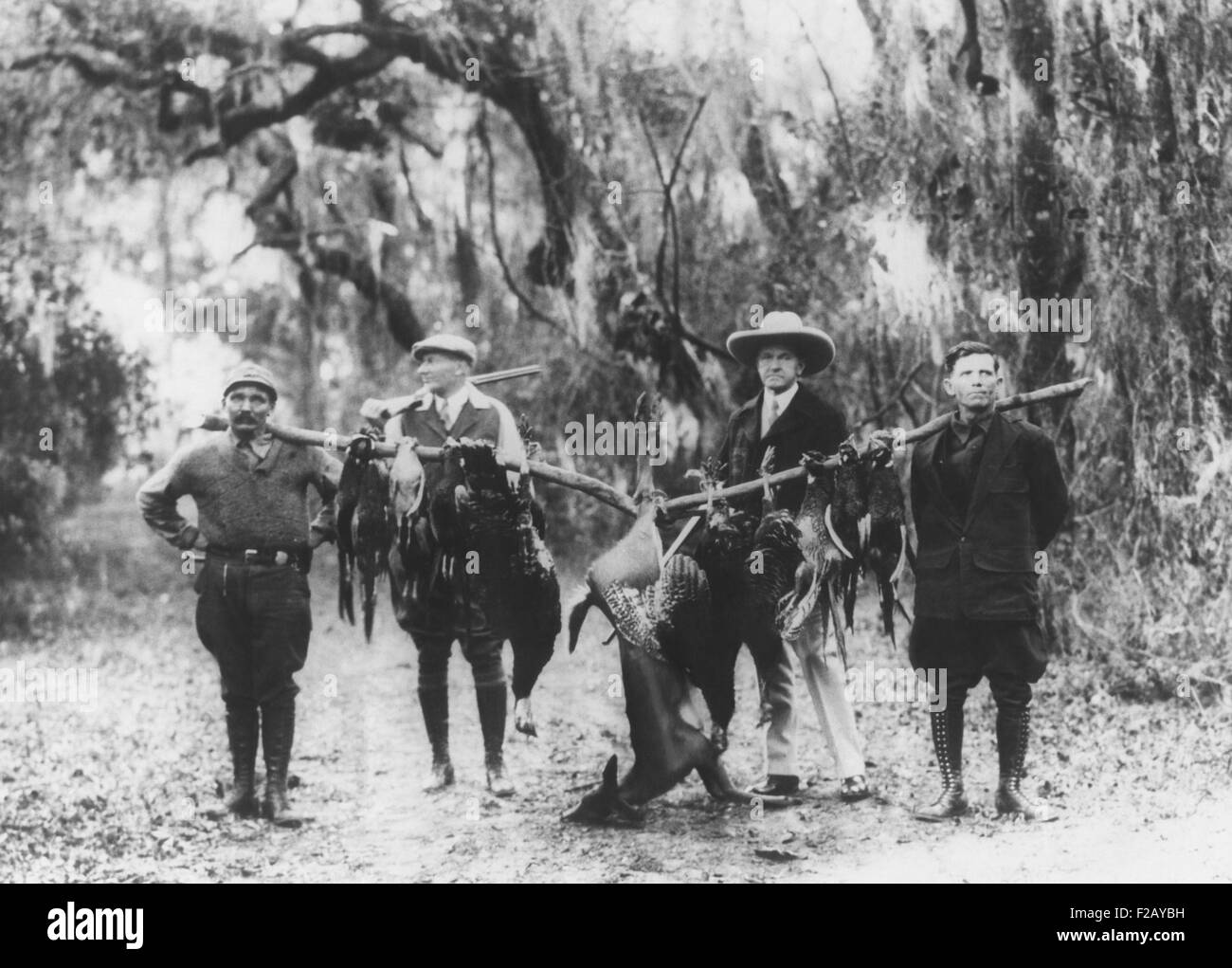 Former President Calvin Coolidge and fellow hunters display their trophies, April 1929. Coolidge was on a vacation hunting trip Stock Photo