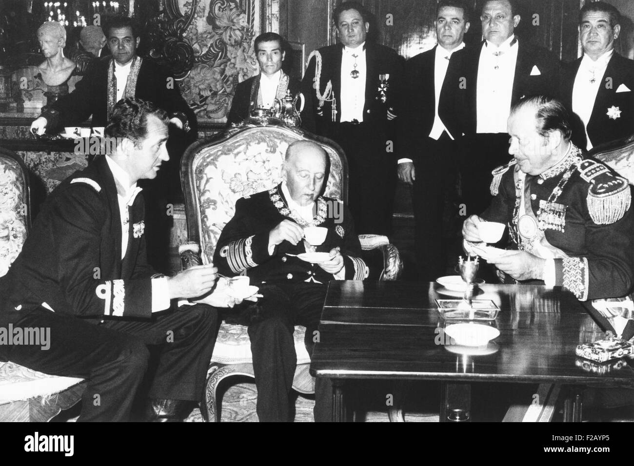 Spanish dictator Francisco Franco (center), hosts Prince Juan Carlos and Gen. Alfredo Stroessner. July 20, 1953. For over 20 years, Franco groomed Juan Carlos, his presumed and later designated successor, in his the ultraconservative politics. Stroessner, was the military dictator of Paraguay from 1954 to 1989. (CSU 2015 9 710) Stock Photo