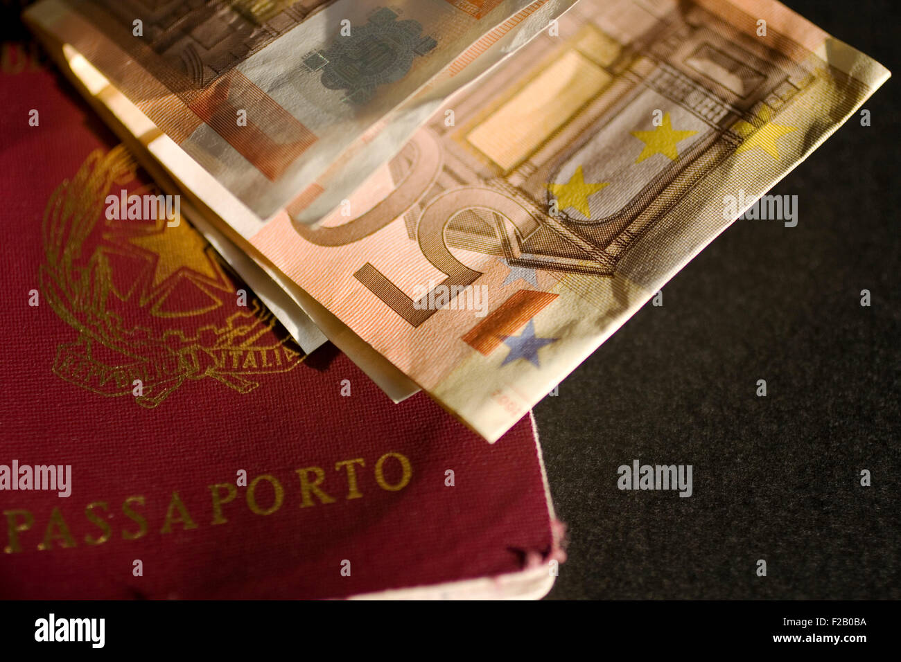 Euro and passport on black background Stock Photo