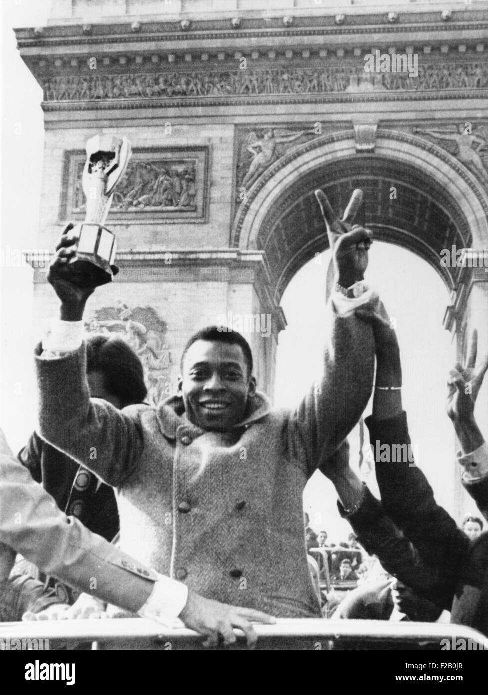 Brazilian soccer star Pele waves the Jules Rimet Cup from an open car on Paris' Champs Elysees. March 30, 1971. In the background is the Arc de Triomphe. Pele played a friendly soccer match at which Bridget Bardot blew the opening whistle and the Foreign Legion provided the band. (CSU 2015 9 1069) Stock Photo