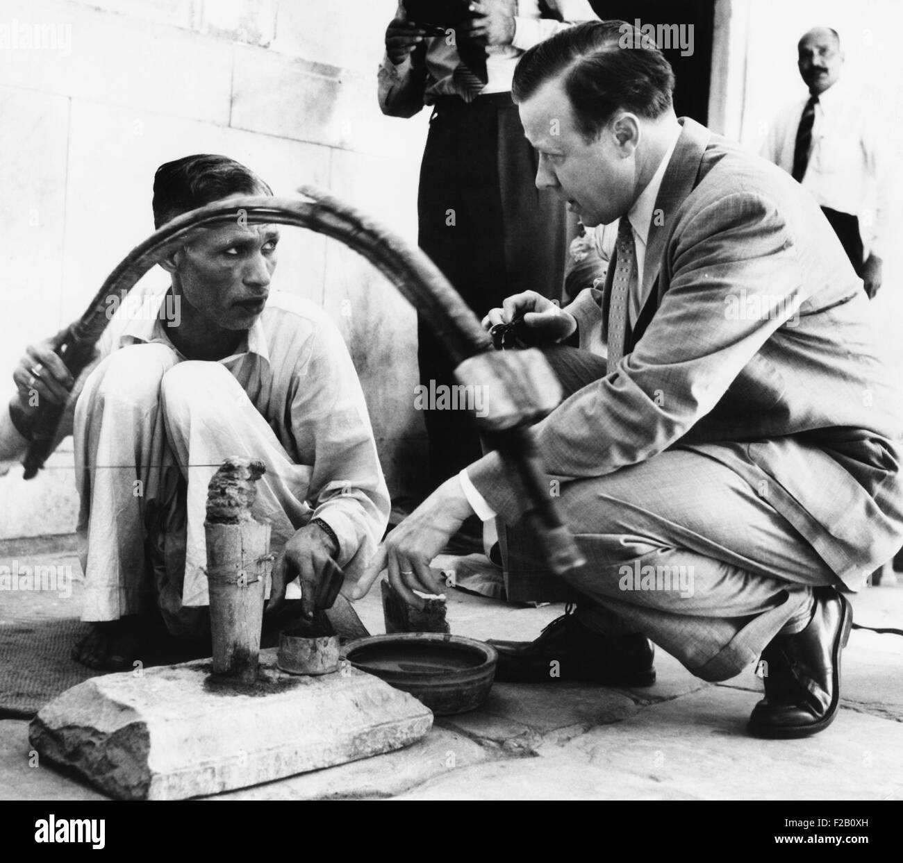 UAW President Walter Reuther talking with an stone cutter in New Delhi ...