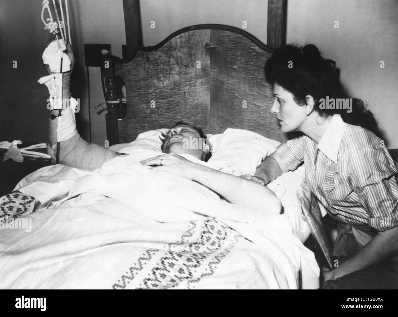 Labor Leader Walter Reuther in hospital after an attempted assassination. His wife, May Reuther, was at his hospital bedside. April 21, 1948. He was in his kitchen when he turn towards his wife, and was hit in the arm instead of the chest and heart, by the blast of a 12 gauge shotgun. The crime was never solved. (CSU 2015 9 1040) Stock Photo