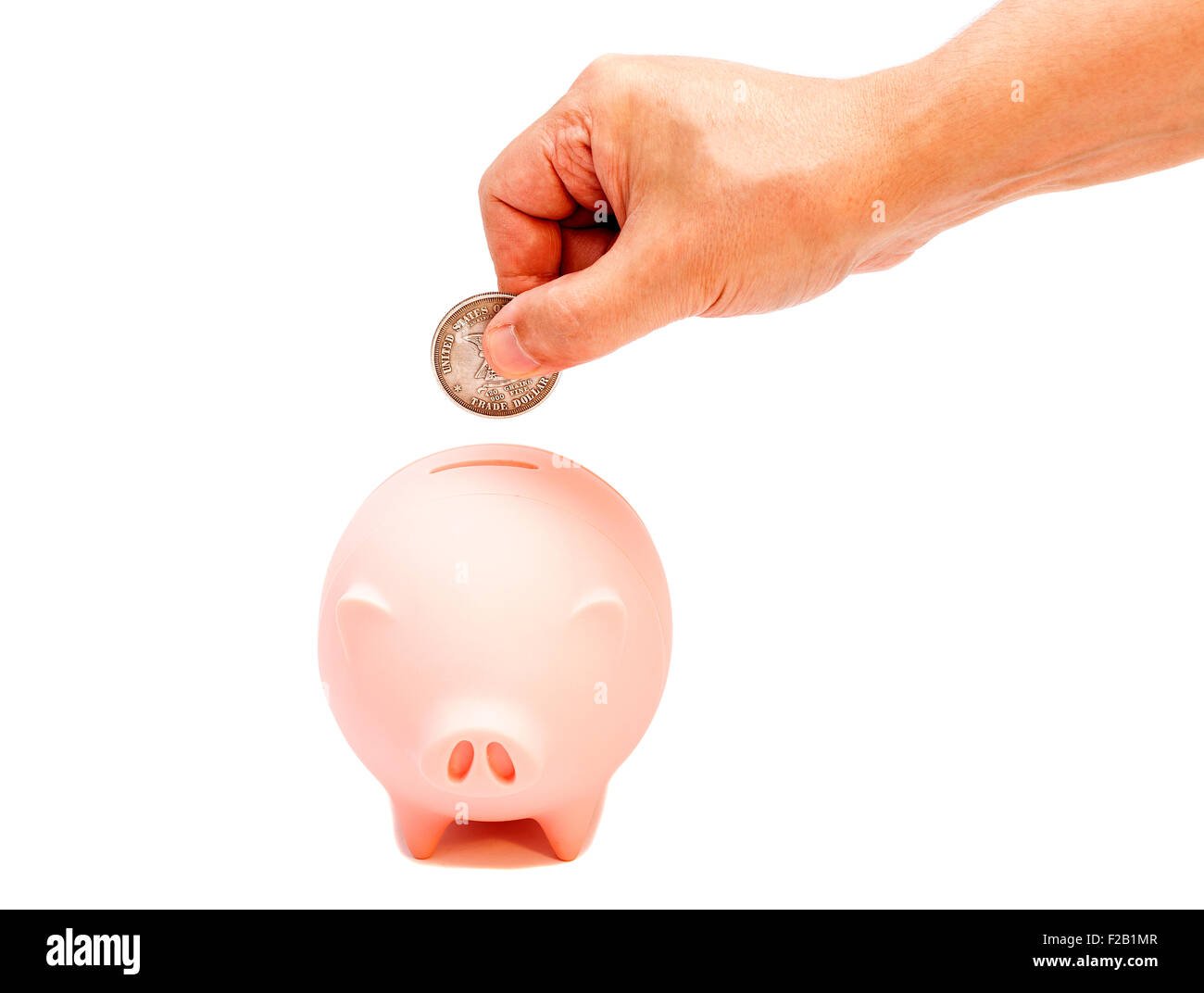 Male hand putting coin into piggy bank isolated on white Stock Photo ...