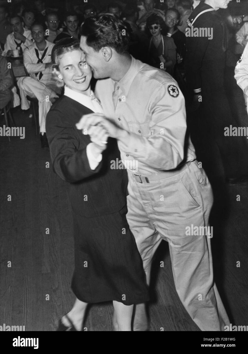 Congresswoman Clare Booth Luce dances with a G.I. at the Washington, D.C. Canteen. She was serving as a Congressional hostess during celebration of the first birthday of 'the service man's heaven'. Sept. 30, 1943. (CSU 2015 8 581) Stock Photo