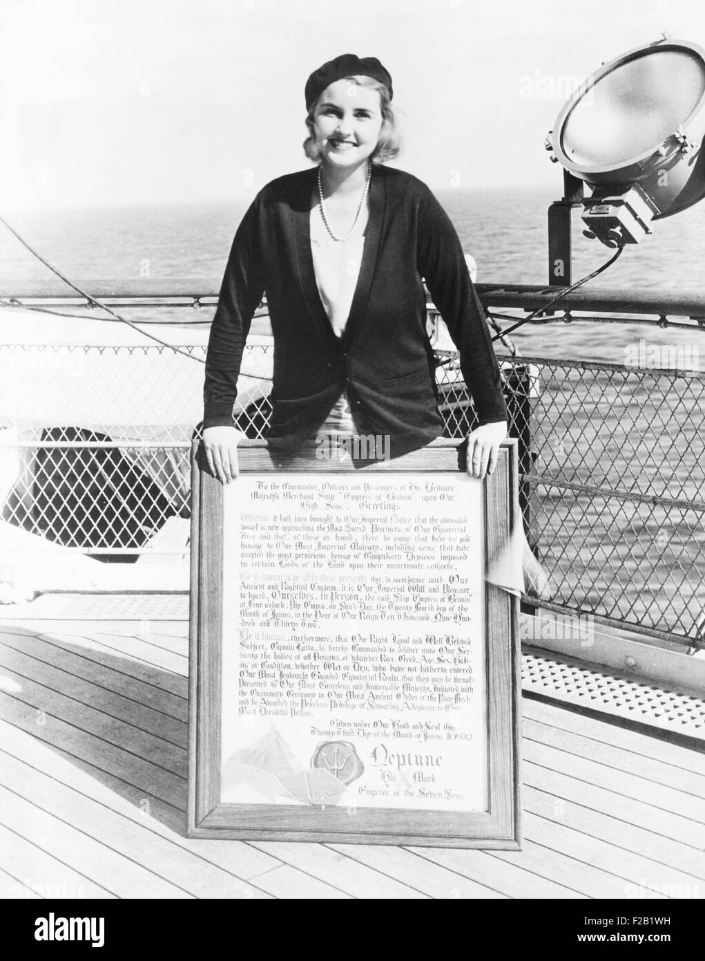Barbara Hutton, Woolworth heiress, on the deck of an ocean liner. She smiles as she displays her diploma from King Neptune. Jan. 23, 1932. (CSU 2015 7 402) Stock Photo