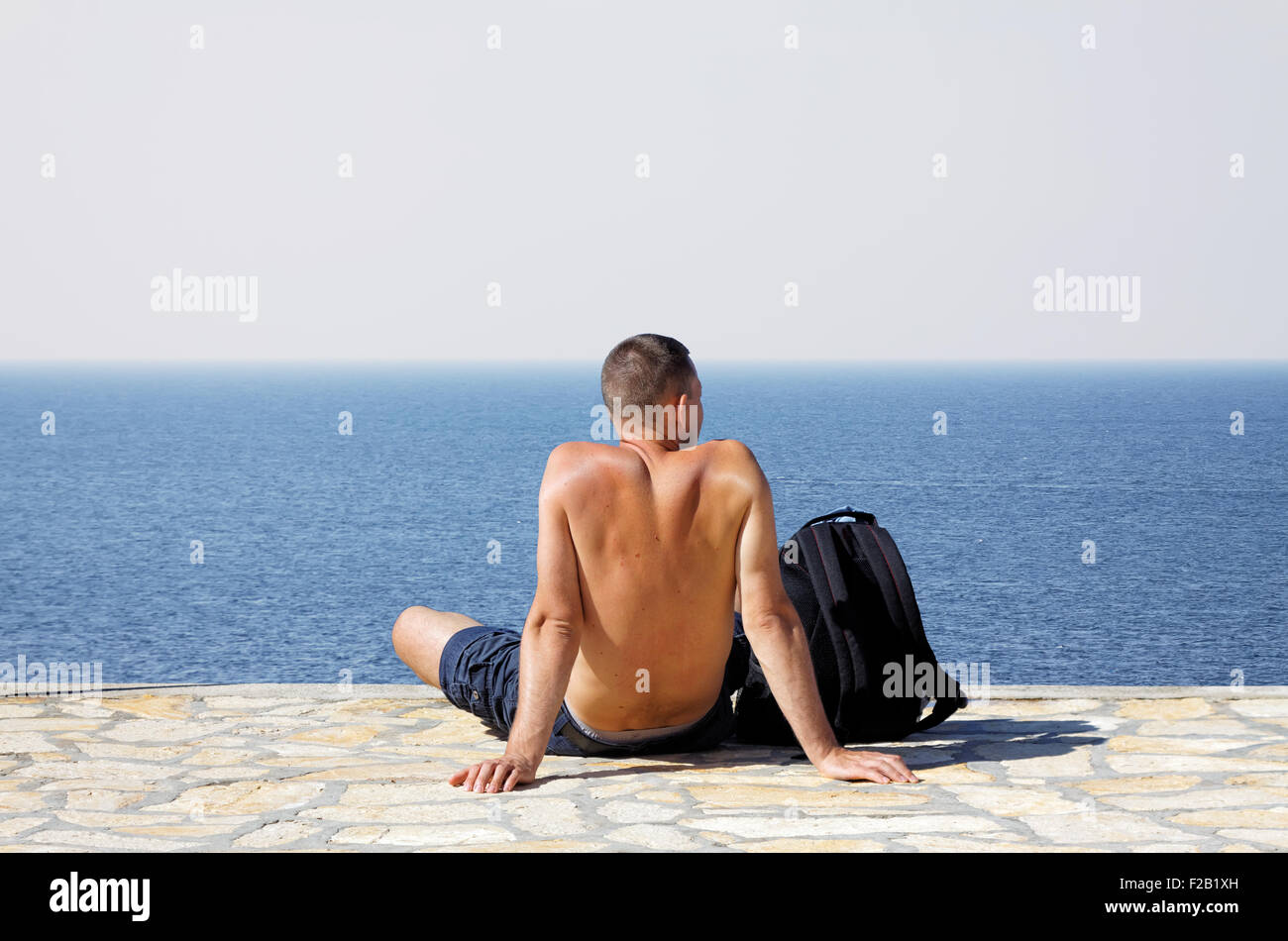 Young man sitting hi-res stock photography and images - Alamy