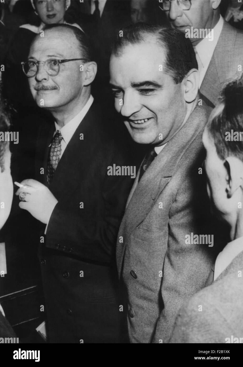Owen Lattimore (left) and Sen. Joseph McCarthy, pass each other during break in Senate hearing. April 20, 1950. McCarthy accused Lattimore of being Russia's top espionage agent, based on the unsubstantiated reports of Louis Budenz, ex-communist. (CSU 2015 8 570) Stock Photo