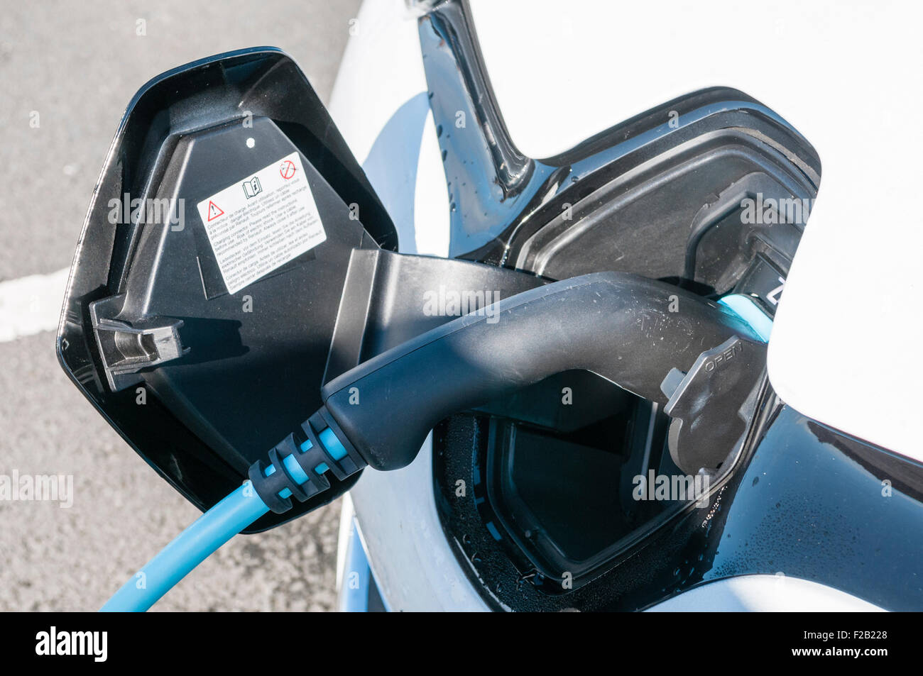 Plug and cable on a Renault Zoe electric car as it is recharged. Stock Photo