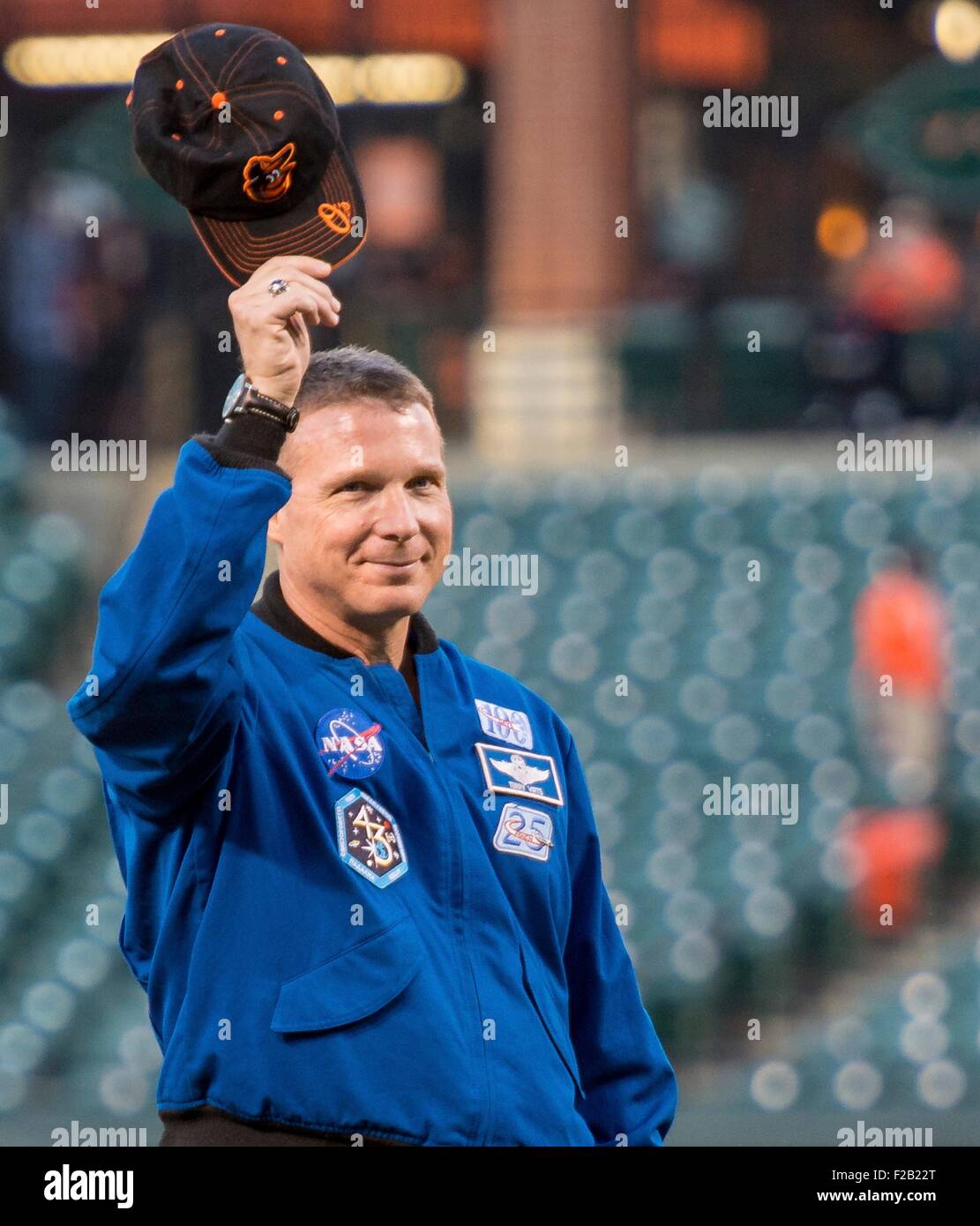 NASA astronaut and Maryland native, Terry Virts waves as he is introduced before throwing the ceremonial first pitch before the Boston Red Sox take on the Baltimore Orioles at Camden Yards baseball stadium September 14, 2015 in Baltimore, Maryland. Virts spend 199 days aboard the International Space Station. Stock Photo