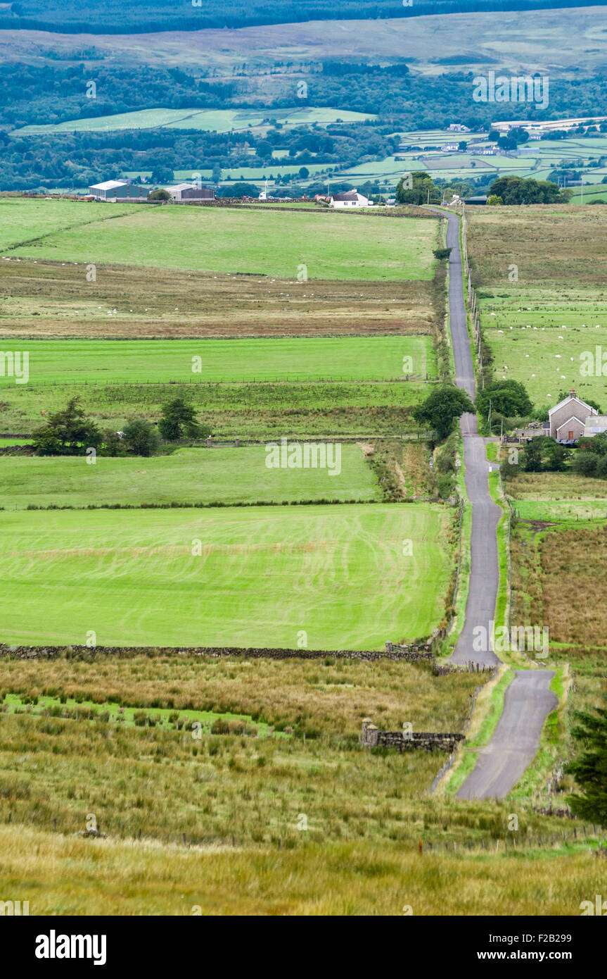 A straight rural road cuts through the countryside Stock Photo