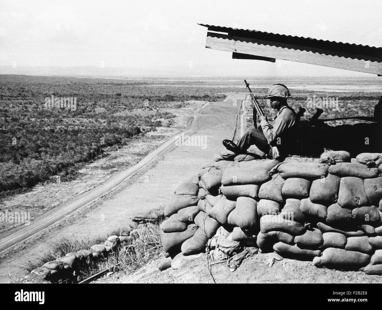 U.S. Marine, looks across into Communist Cuba from Guantanamo Naval Base Cuba. Feb. 16, 1964. The U.S. has occupied the area since it was captured from Spain in the Battle of Guantanamo Bay, during the Spanish American War in 1898. (CSU 2015 7 377) Stock Photo