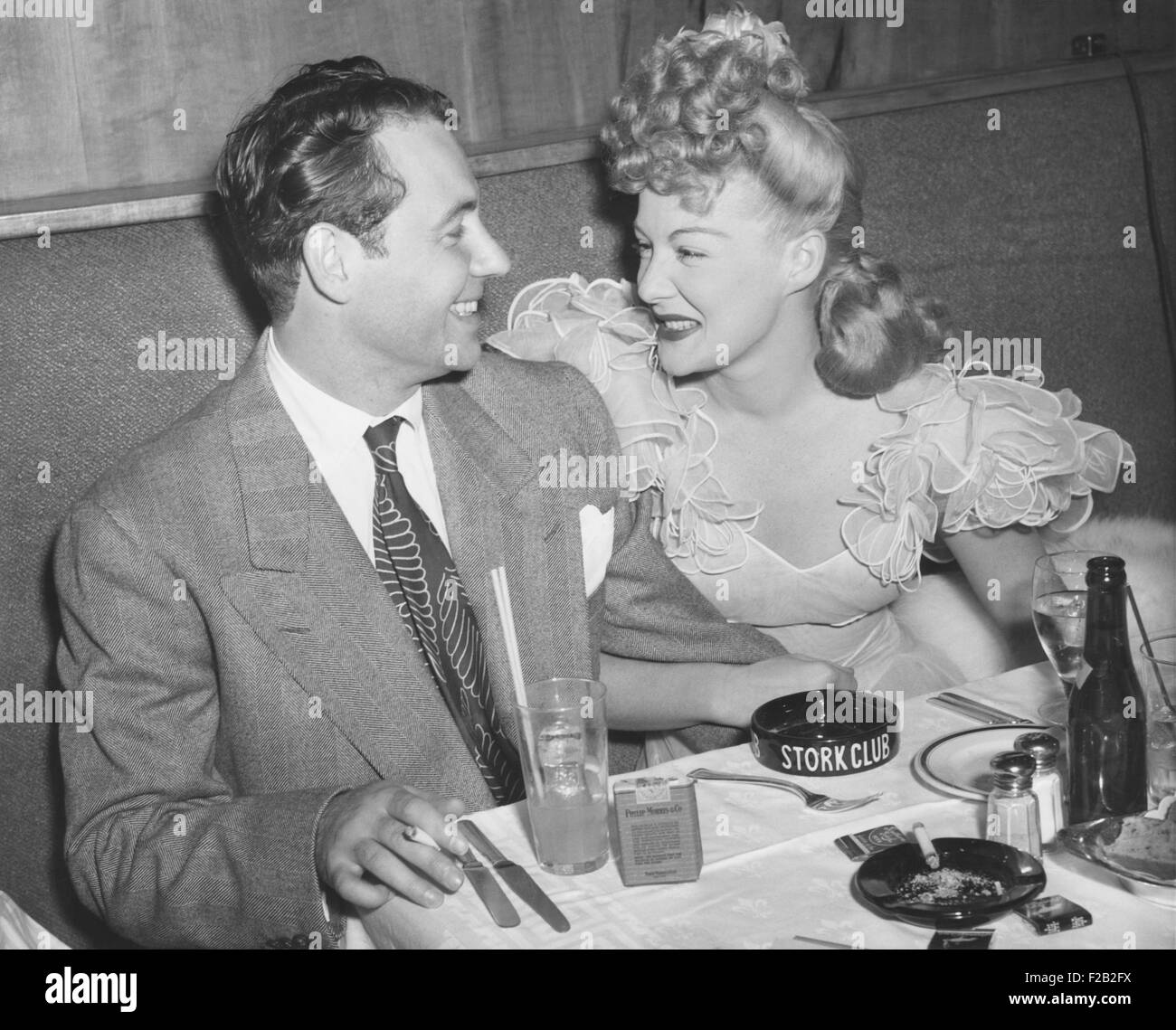 Movie star Betty Hutton with her fiance, newscaster, in Charles Martin at the Stock Club. New York City, Sept. 2, 1943. They never wed, instead she married Ted Briskin on Sept. 3, 1945. (CSU 2015 7 356) Stock Photo