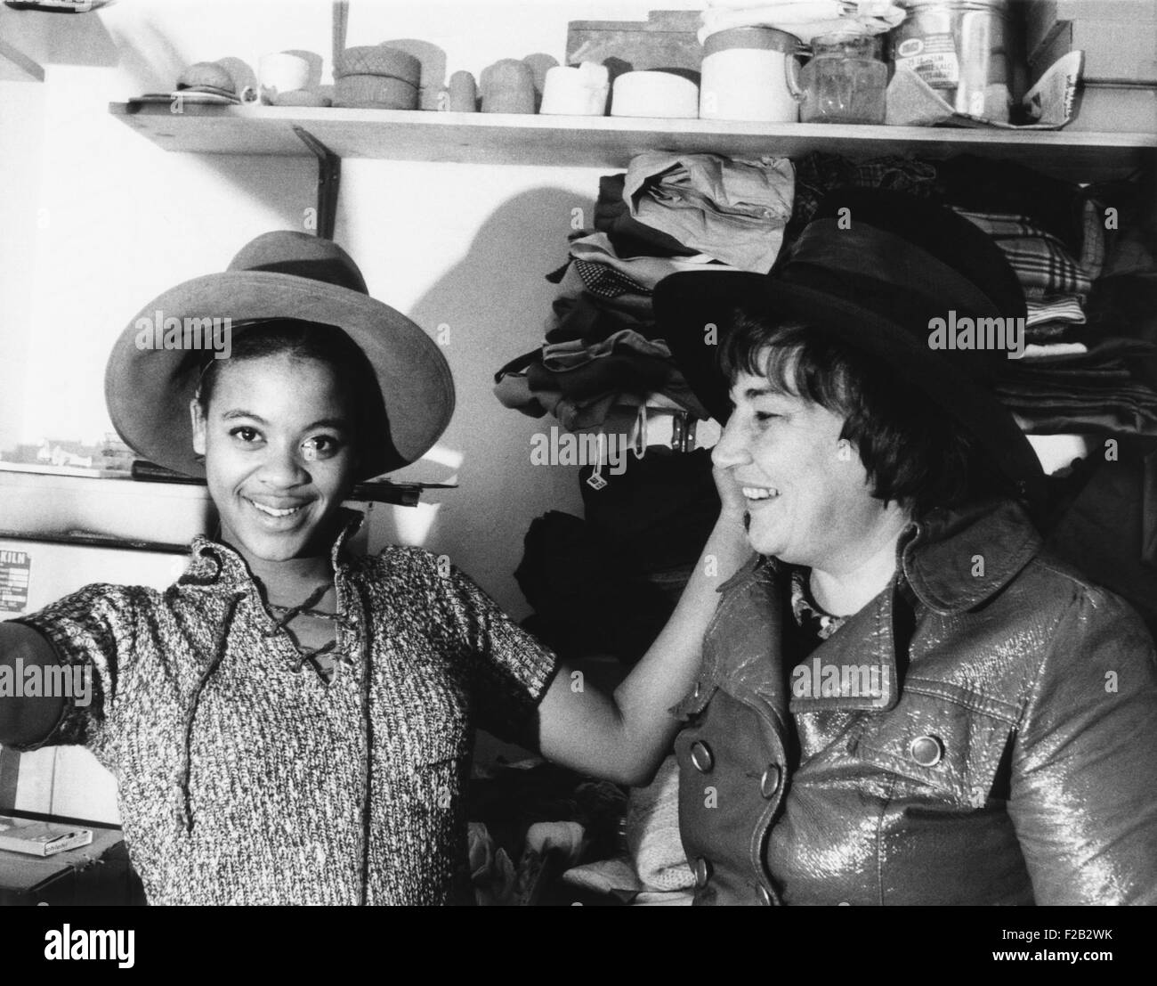 A high school student tries on one of Bella Abzug's wide brimmed campaign hats. Congresswomen-elect Abzug donated the hat to the boutique, 'Square Business', operated by a New York City School. Dec. 18, 1970. (CSU 2015 7 319) Stock Photo