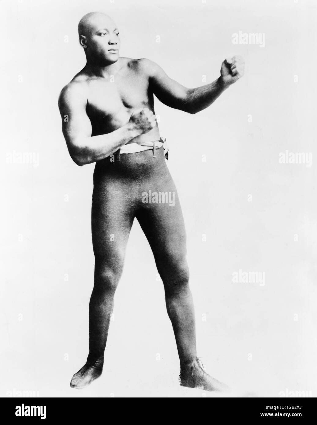 Jack Johnson in a fighting pose. He became the first African American world heavyweight boxing champion after knocking out Tommy Burns, a Canadian boxer, in Sydney, Australia, in 1908. He held the title until his April 5, 1915, defeat by Jess Willard. (CSU 2015 7 313) Stock Photo