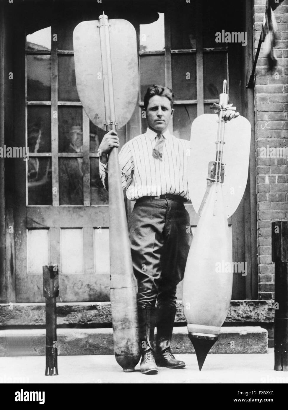 Lester P. Barlow with two bombs he invented, Jan. 22, 1926. He invented a 'flying torpedo' and 'bouncing bomb'. (CSU 2015 8 479) Stock Photo