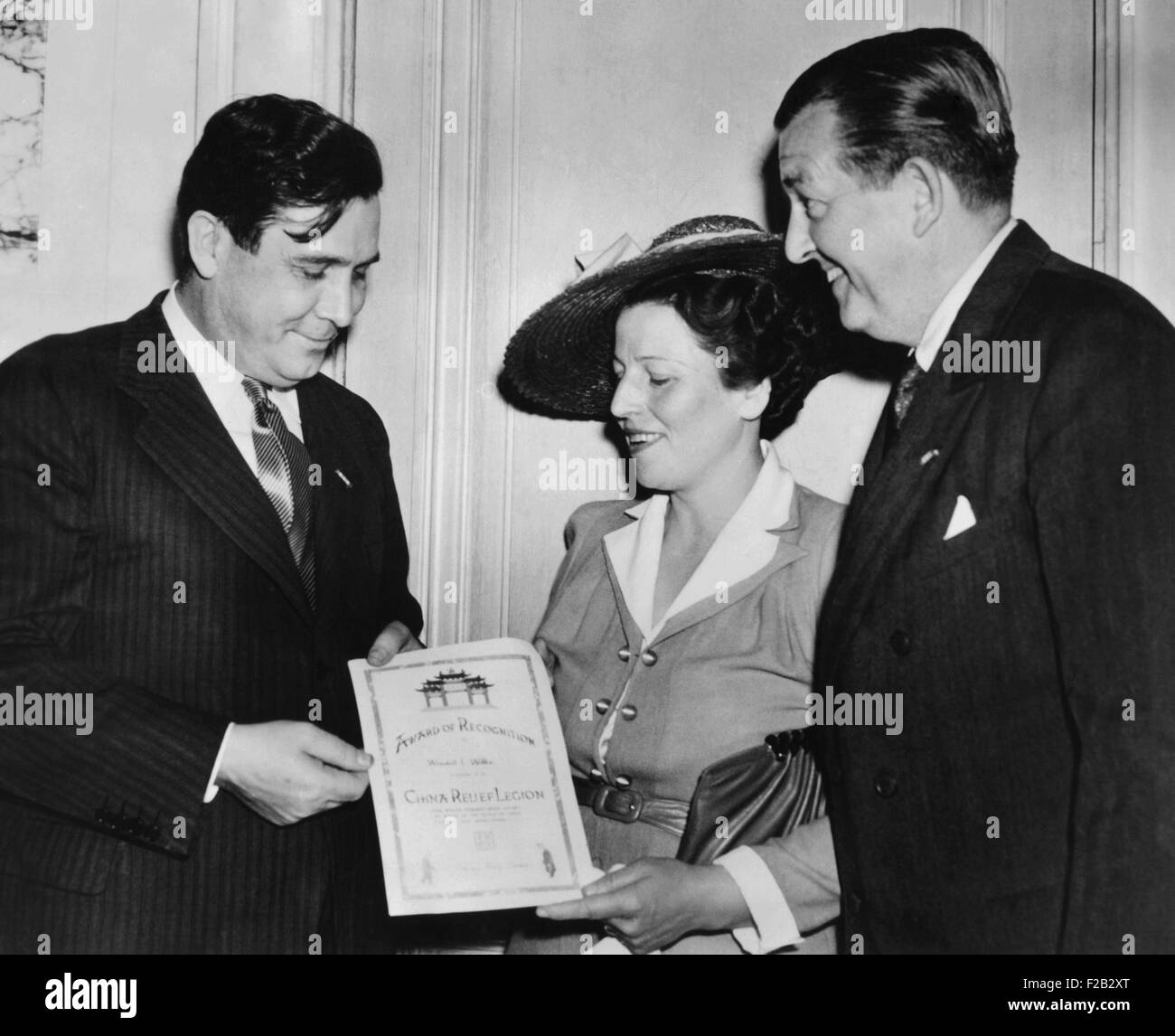 Author Pearl Buck presents Wendell Willkie with a United China Relief Fellowship Certificate. United China Relief was founded in 1941 in NYC to raise funds to aid the Chinese people during World War II. At right is James G. Blaine. (CSU 2015 8 473) Stock Photo