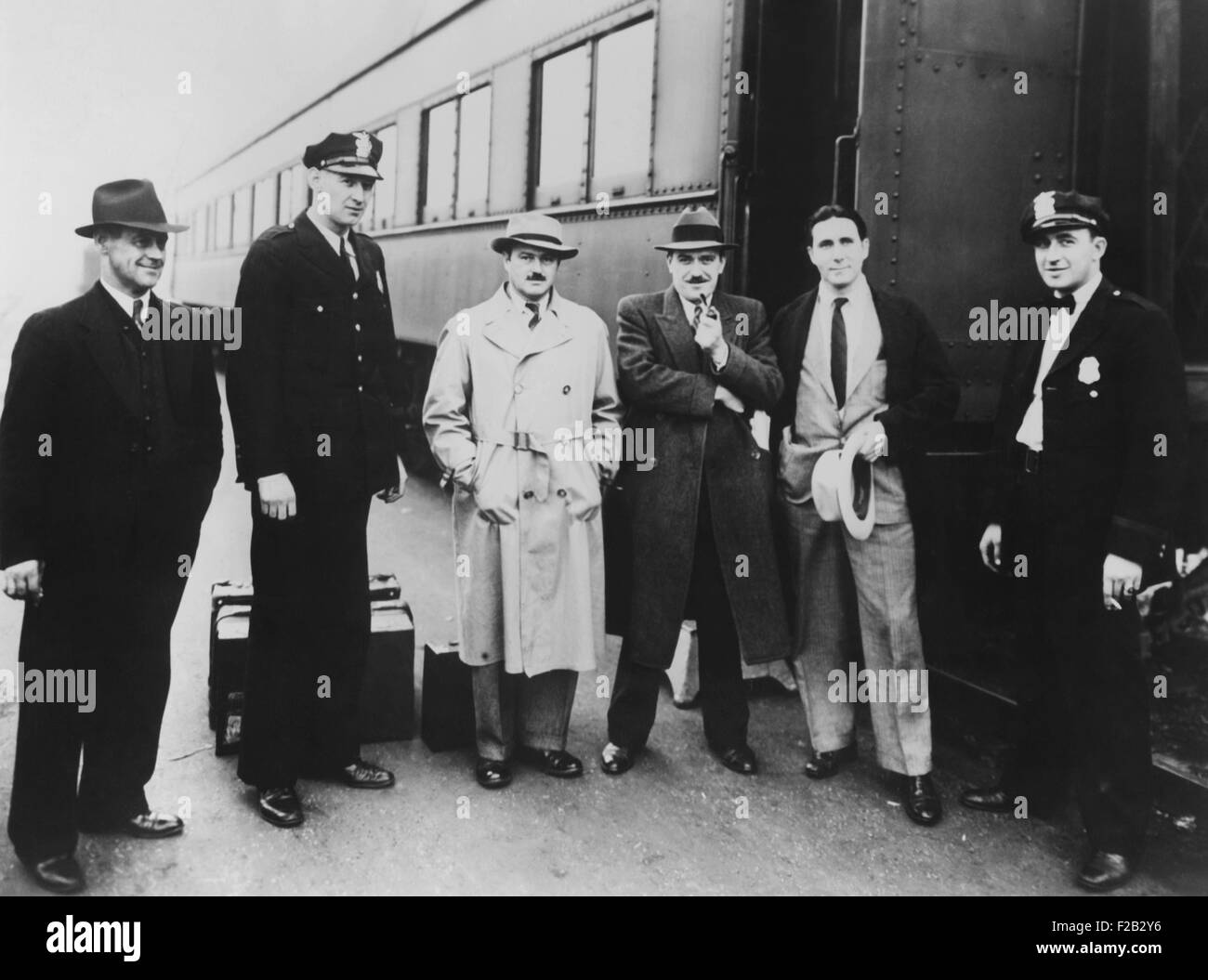 Earl Browder, Communist candidate for President, was arrested as he arrived in Terre Haute, Indiana. Sept. 30, 1936. Browder and four companions were held on vagrancy charges. L-R: H. A. Collins, Sec.Vigo County Law and Order League; unidentified policeman; Waldo Frank, New York novelist; Earl Browder; Seymour Waldman, of New York; unidentified policeman. (CSU_2015_8_468) Stock Photo