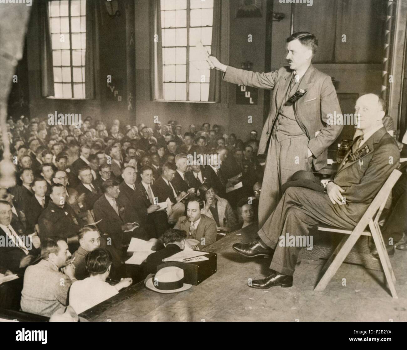 Earl Browder, making the keynote address at the Communist Party Convention, Chicago, May 29, 1932. Browder was National Secretary of the CPUSA and would be it's candidate for President in the 1932 National election. William Foster, seated beside him, ran as CPUSA vice presidential candidate. (CSU 2015 8 466) Stock Photo