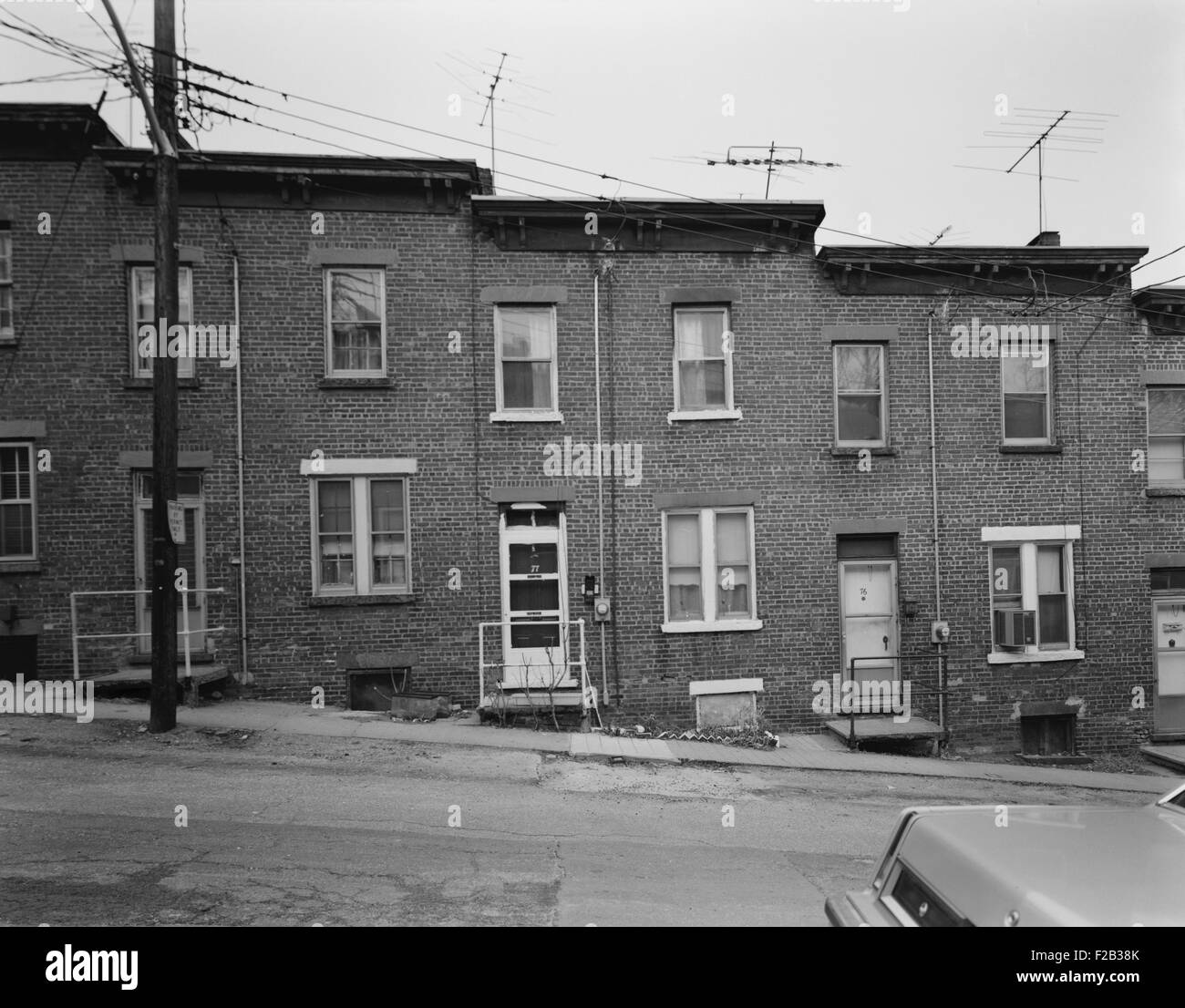 Yonkers, New York, ca. 1980. Moquette Row Housing was built between 1886 and 1889. Each bonds to its neighbors in a continuous row along the hill slope. View north showing front elevation. Westchester County, NY. (BSLOC 2015 11 7) Stock Photo