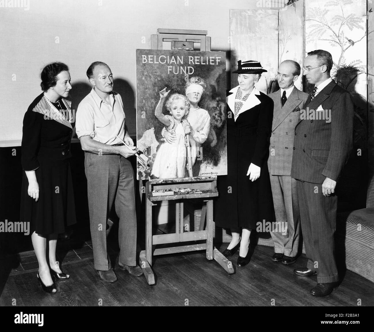 McClelland Barclay illustrated the official poster of the Belgian Relief Fund, Inc. In June 1940, after Hitler's conquest of Western Europe, the Fund unified American relief efforts in behalf of the Belgian refugees. L-R: Ms. Suzanne Silvercruys Stevenson; Mr. Barclay; Mme. Charles Jannsen; Milton M. Brown; and Perrin C. Calpin. - (CSU 2015 6 217) Stock Photo