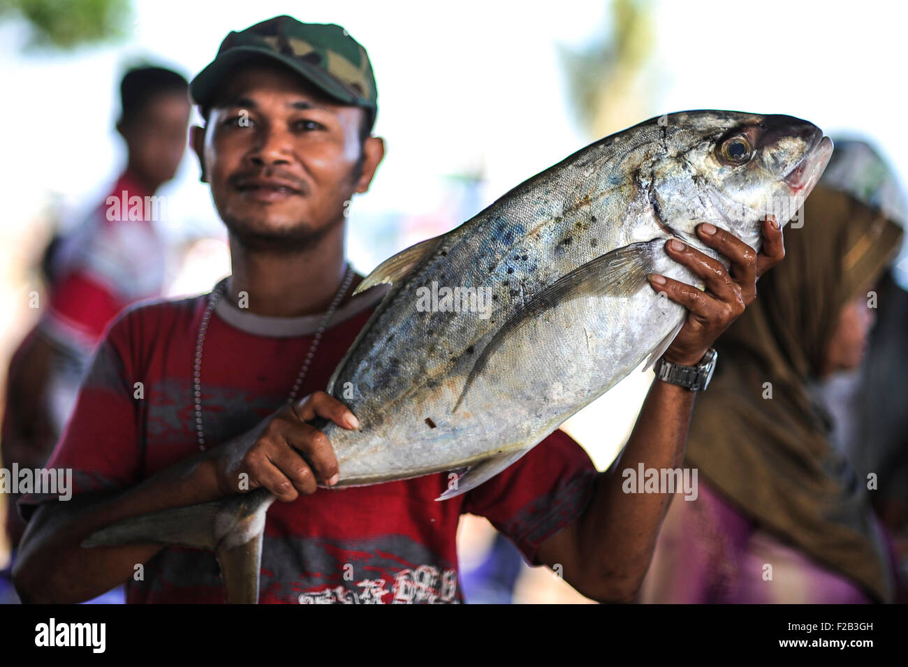 Indonesian fisherman shows off catch hires stock photography and