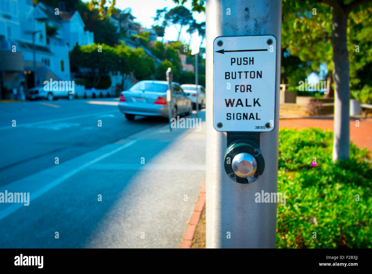 Walk Signal on post next to road in Town in California Stock Photo