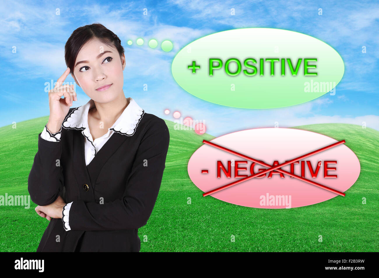 Business woman thinking about positive with green grass field and blue sky background Stock Photo