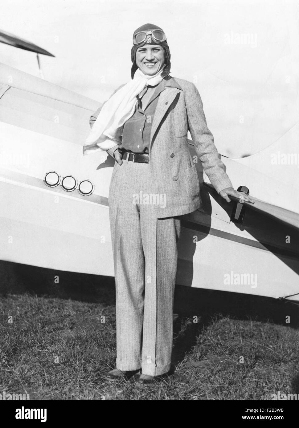 Jacqueline Cochran, sports woman pilot, at Roosevelt Field NY with her monoplane. Jackie Cochran is now preparing for the forthcoming National Air Pageant. She wears a trouser suit of imported gray tweed, soft sport shirt, and scarf of white parachute silk. Oct. 5, 1933 - (CSU 2015 5 32) Stock Photo