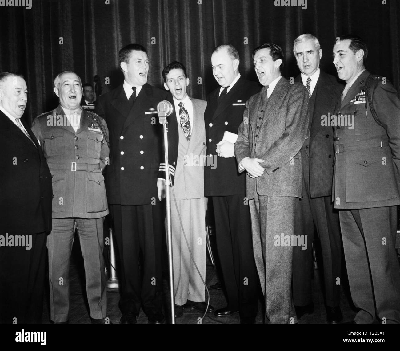 An all star octet entertains visiting editors and publishers at the Banshees' Luncheon. April 25, 1944, Grand Ballroom of the Waldorf Astoria Hotel, NYC. L-R: George McManus, cartoonist; Brig. Gen. Robert Denig, USMC Public Relations; Gene Tunney, Frank 'The Voice' Sinatra; Capt. Leland  Lovett, USN Public Relations; George Healy OWI, Chief, Domestic Div.; Jesse Jones, Dir. RFC; and Brig. Gen. Jerry Thomas, USMC. The Luncheon was given on the occasion of the opening of the 58th Annual Convention of the American Newspaper Publishers Assn. - (CSU 2015 5 154) Stock Photo