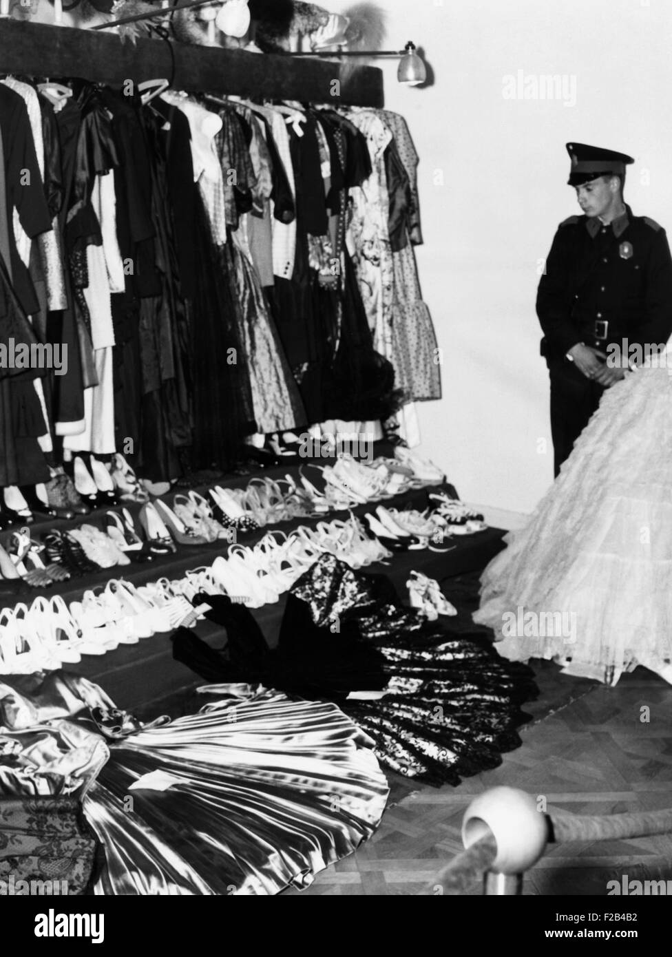 Soldier guards the late Eva Peron's luxury after the overthrow of  Argentina's dictator Juan Peron. In addition to jewelry, paintings, ivory  carvings and other riches, her closets held 400 dresses, 600 hats