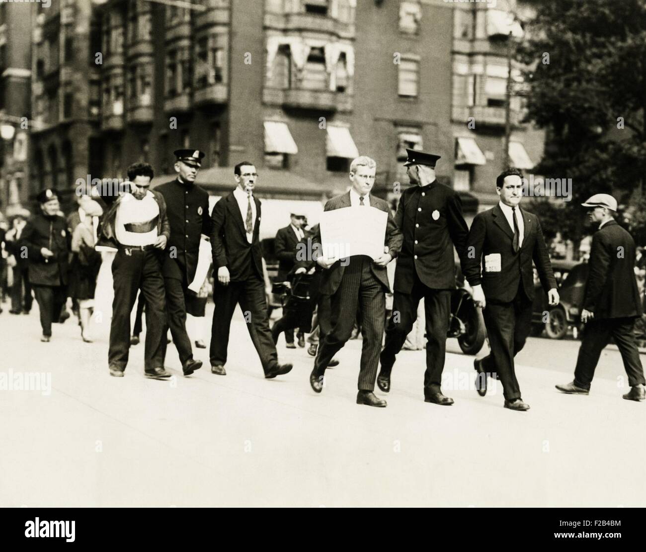 Socialists arrested in Boston, Mass. Harry Canter of N.Y. (left) and Alfred Baker Lewis of Boston, both Socialists, being escorted by the police after being arrested for disturbing the peace. They are sympathizers of Sacco and Vanzetti. Ca. Aug. 13, 1927. - (CSU 2015 5 111) Stock Photo