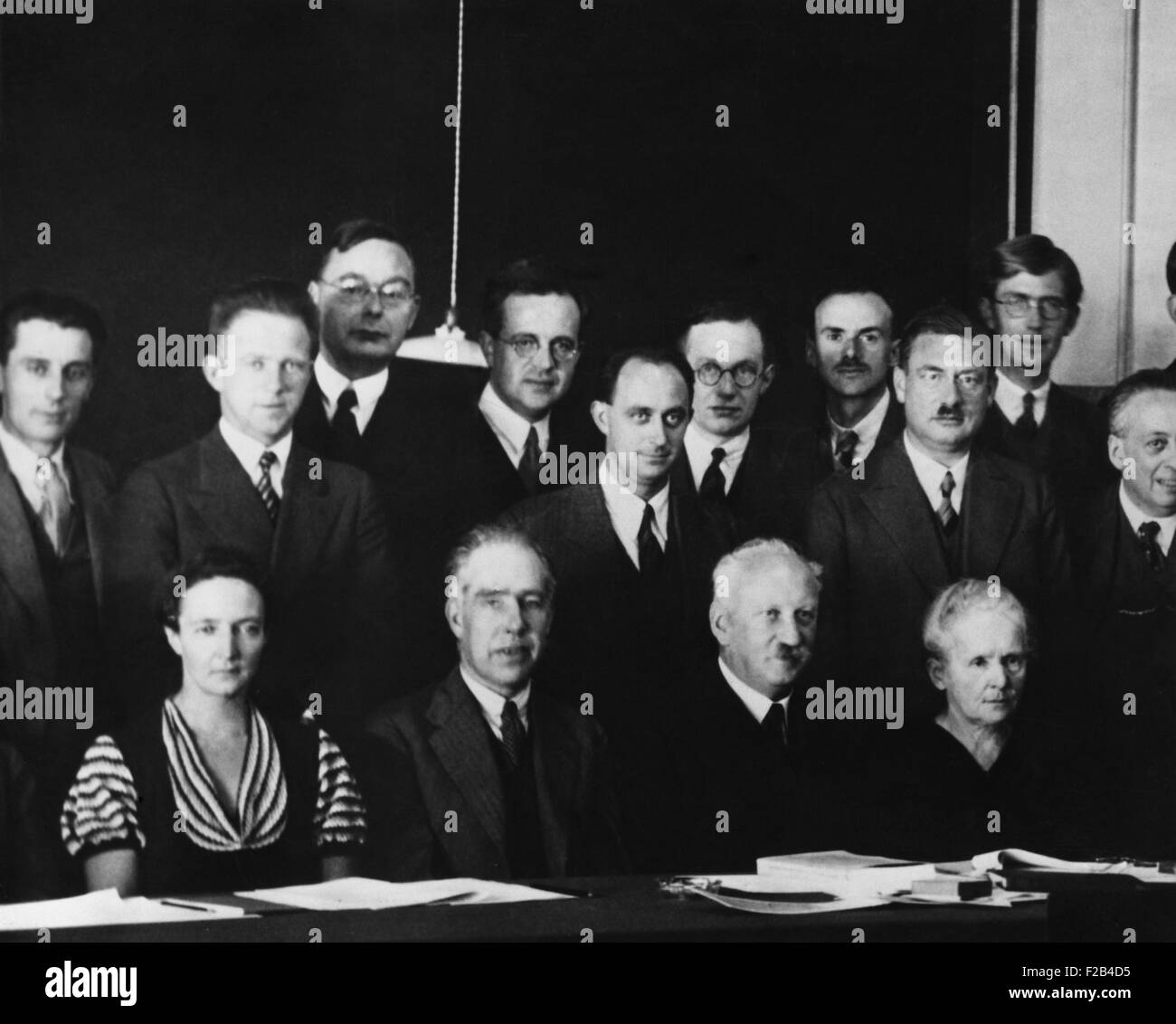Physicists at the Seventh Solvay Physics Conference, Brussels, Belgium, October 1933. Seated, L-R: Irene Joliot-Curie, Niels Bohr, Abram Ioffe, Marie Curie. Standing, L-R: no ID, Werner Heisenberg, Hendrik Kramers, Ernest Stahel, Enrico Fermi, Ernest Walton, Paul Dirac, Peter Debye, Nevill Mott, Blas Cabrera, Frederic Joliot. - (BSLOC 2015 1 78) Stock Photo