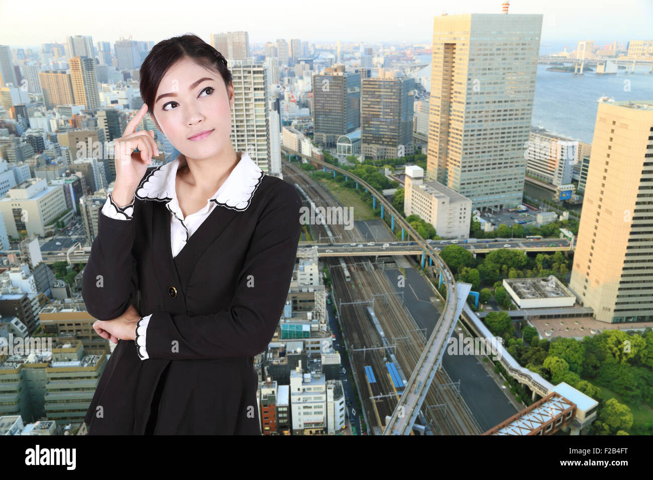 Business woman thinking with city background Stock Photo