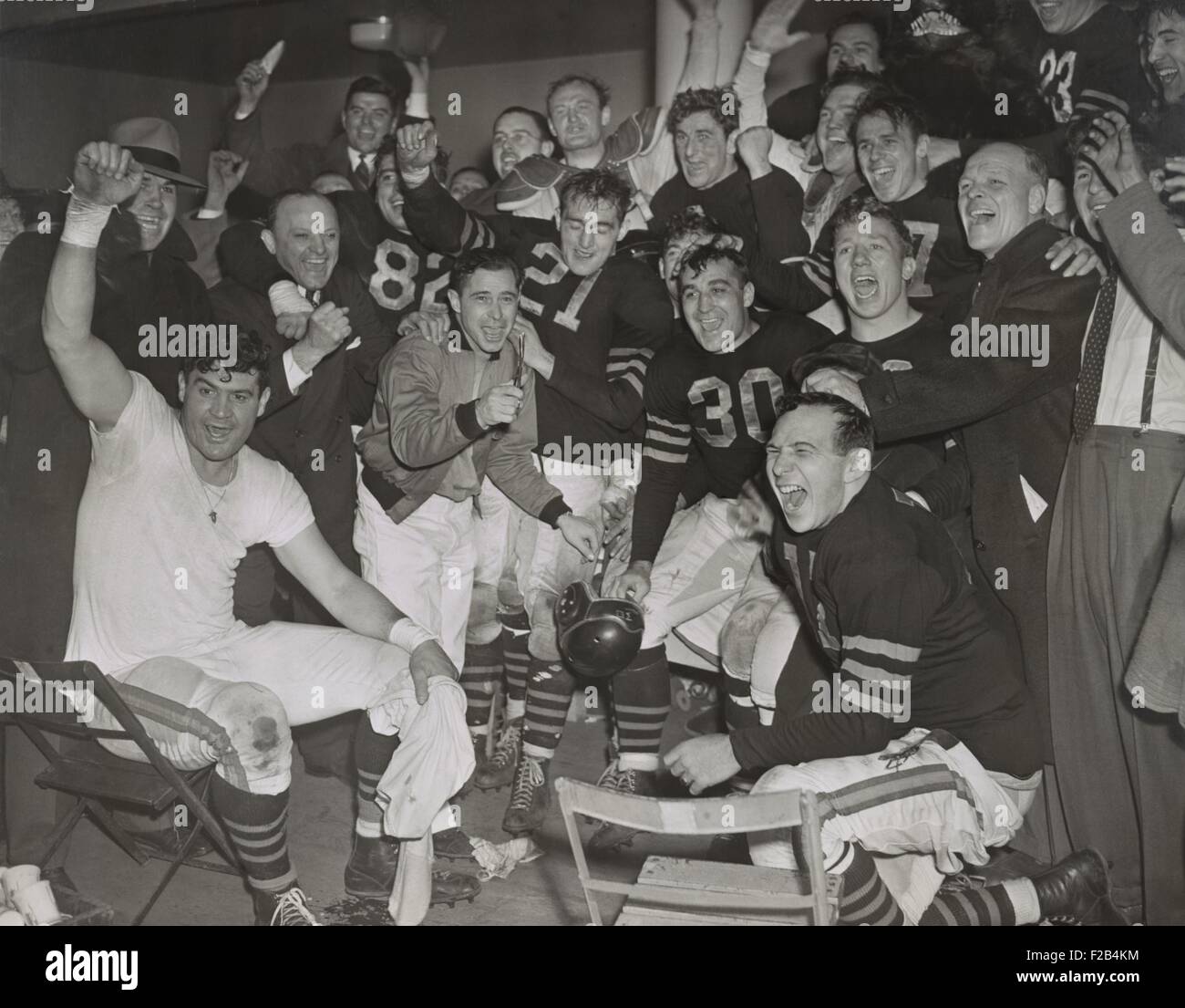 Chicago Bears cheering after beating the Green Bay Packers in the western division playoffs. 2nd from left, standing, is owner-coach George Halas. At far right is line coach Hartley 'Hunk' Anderson. - (BSLOC 2015 1 214) Stock Photo