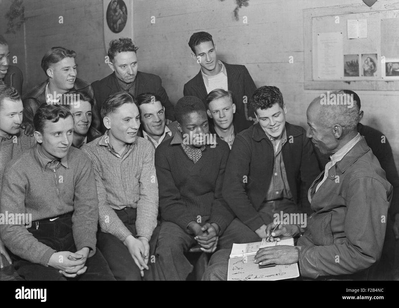 Unemployed men attending a meeting of the Workers' Alliance Council in 1936. Most are young second generation miners. The integrated group with an African American meeting leader are consistent with the leftist (Socialist and Communist) orientation of the Workers' Alliance Council. Photo by Lewis Hine. - (BSLOC 2015 1 173) Stock Photo