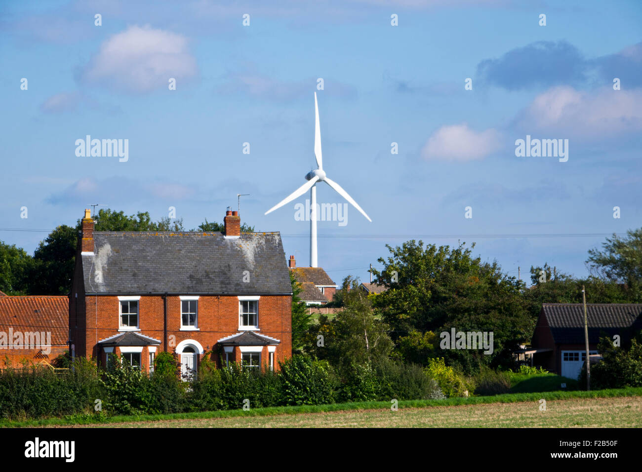 wind turbine and house in countryside Stock Photo