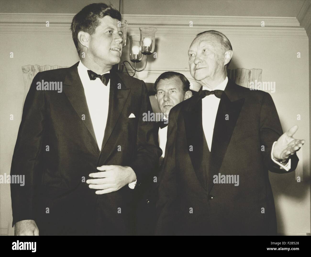 West German Chancellor Konrad Adenauer with President John Kennedy at the German Embassy. Nov. 21, 1961. West Germany and West Berlin were among the most contentious places of the Cold War. West German Ambassador to the U.S. Wilhelm Grewe is in the background. - (BSLOC 2015 1 134) Stock Photo