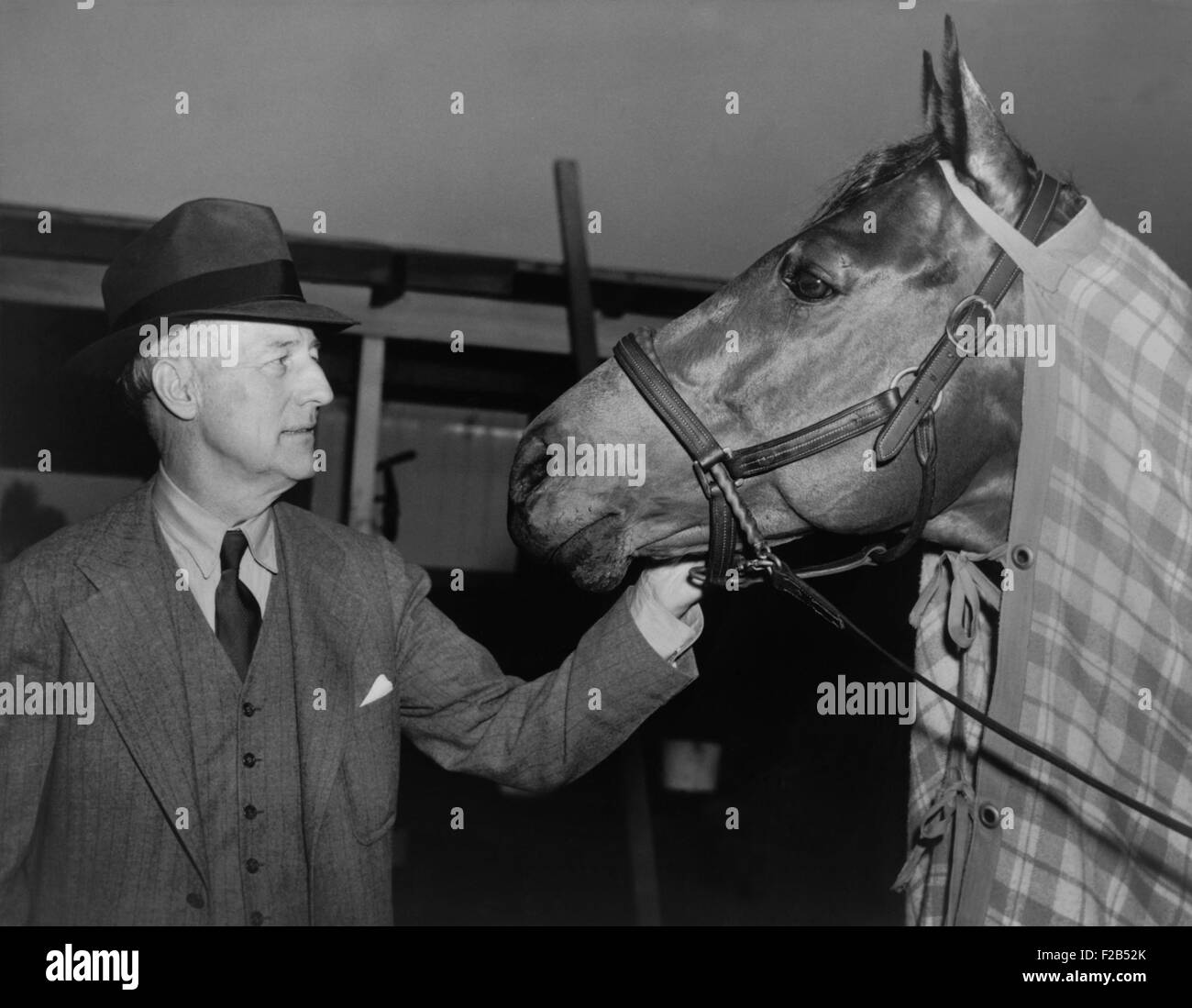 Charles Howard admiring his horse Seabiscuit, March 5, 1940. Seabiscuit had just won the Santa Anita Handicap. - (BSLOC 2015 1 124) Stock Photo