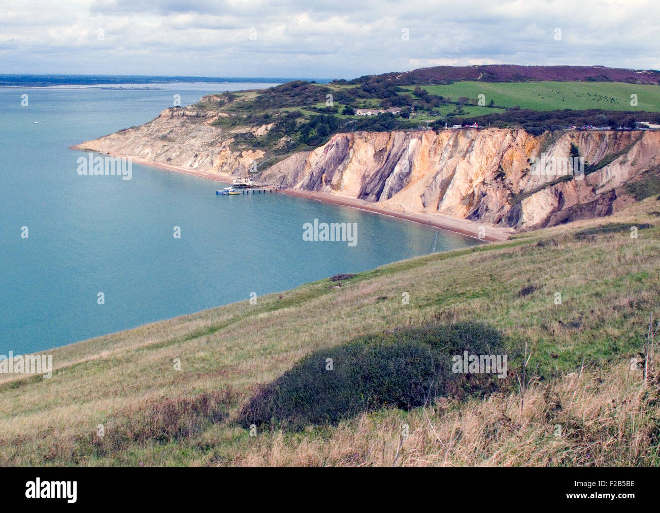 A view of Alum Bay from the cliff leading to The Needles on the most western point of the Isle of Wight. Of geological interest and a tourist attraction, the bay is noted for its multi-coloured sand cliffs. Stock Photo