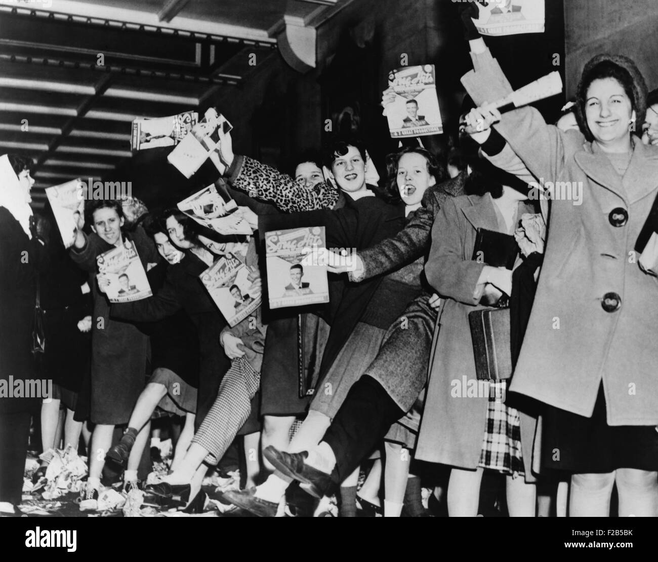 Teenage girls waiting for singer Frank Sinatra to arrive at the Paramount Theatre. 1945 in New York City. - (BSLOC_2014_17_78) Stock Photo