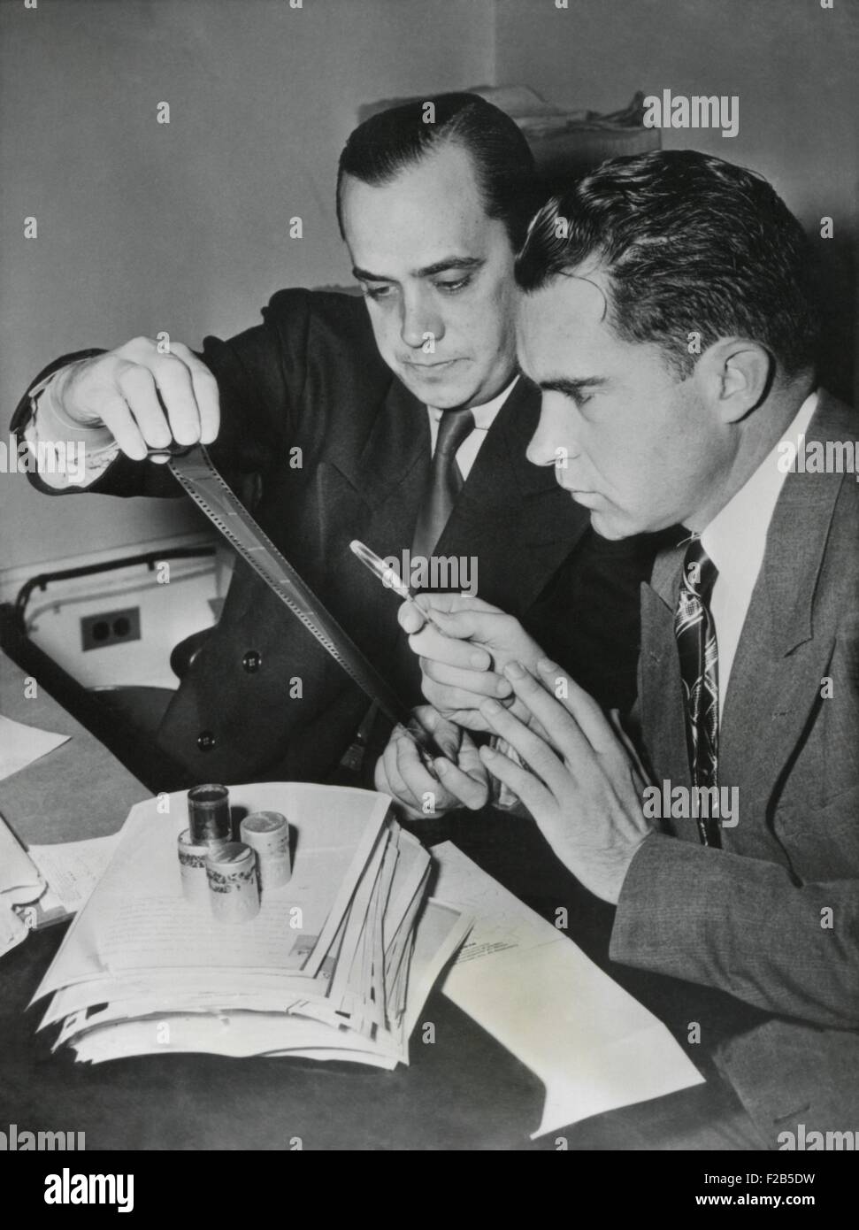 Richard Nixon examines the 'Pumpkin Paper' microfilms with Robert Stripling, HUAC Chief Investigator. The film contained 64 U.S. government documents Alger Hess copied for transfer to Soviet Union in 1937. Dec. 6, 1948. - (BSLOC 2014 17 23) Stock Photo
