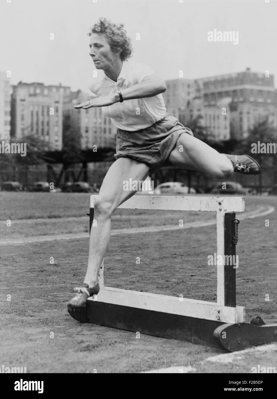 Fanny Blankers-Koen clearing a low hurdle at McCombs Dam Park in the Bronx, 1949. The Dutch athlete won four gold medals at the Stock Photo