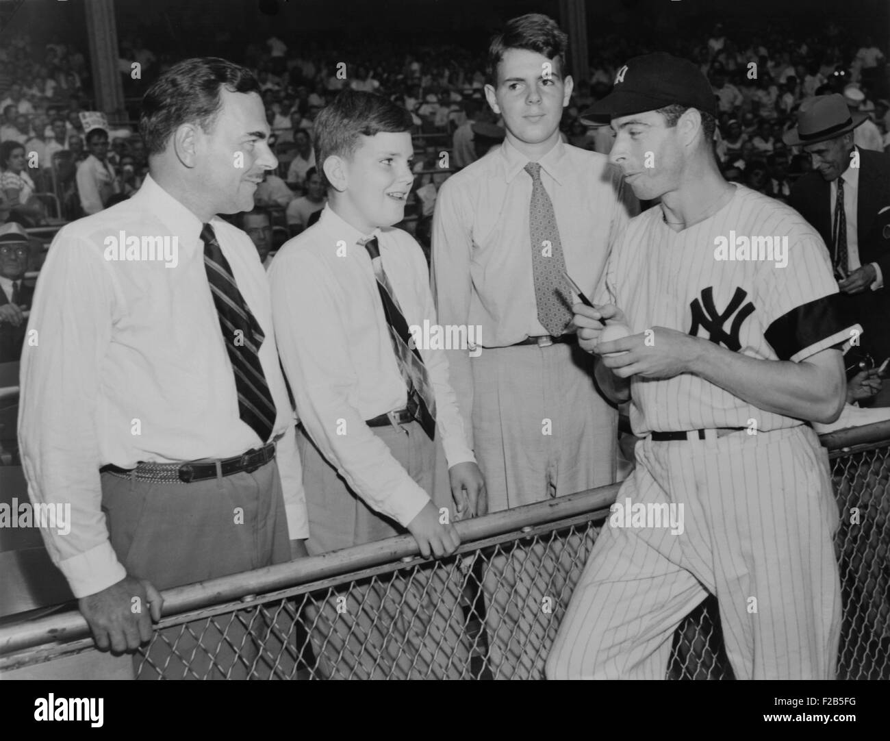 Joe Di Maggio autographs baseball for Gov. Thomas Dewey's sons, Tommy and Johnny. 1948. - (BSLOC 2014 17 166) Stock Photo