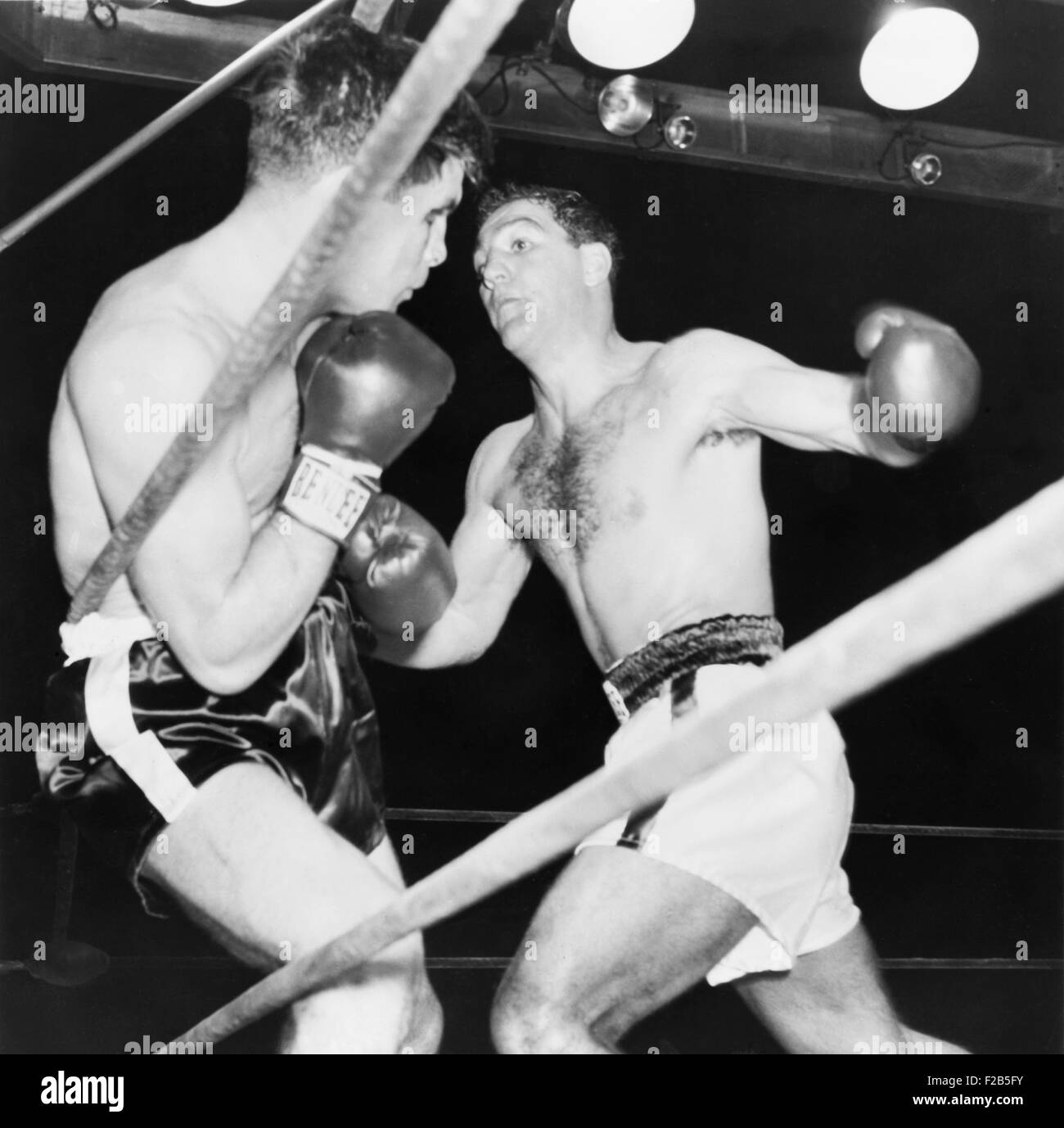 Heavyweight champion Rocky Marciano (right) backs Roland LaStarza against the ropes. Sept. 24, 1953. LaStarza lost the fight and became an actor and played 'tough guy' roles. He appeared in movies Point Blank (1967) and The Outfit (1973). - (BSLOC 2014 17 157) Stock Photo