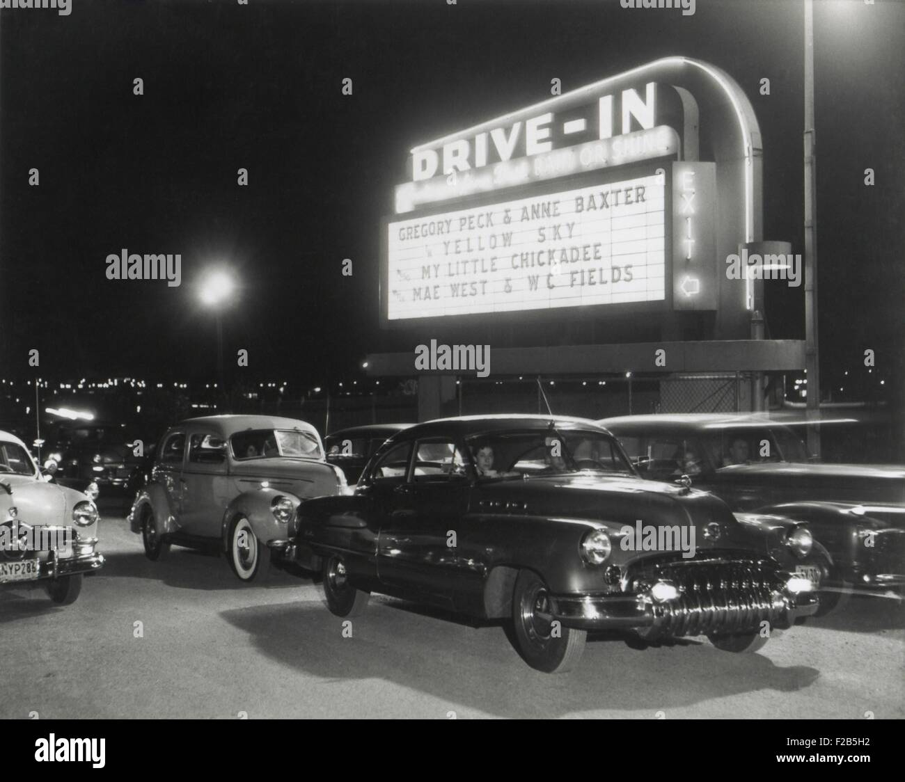 Cara at the Whitestone Bridge Drive-In Theater which opened in August 1949. The Drive-In Theater could accommodate 1,200 cars and was open 8 months of the year. It was showing a double feature, YELLOW SKY and MY LITLE CHICKADEE. - (BSLOC 2014 17 129) Stock Photo
